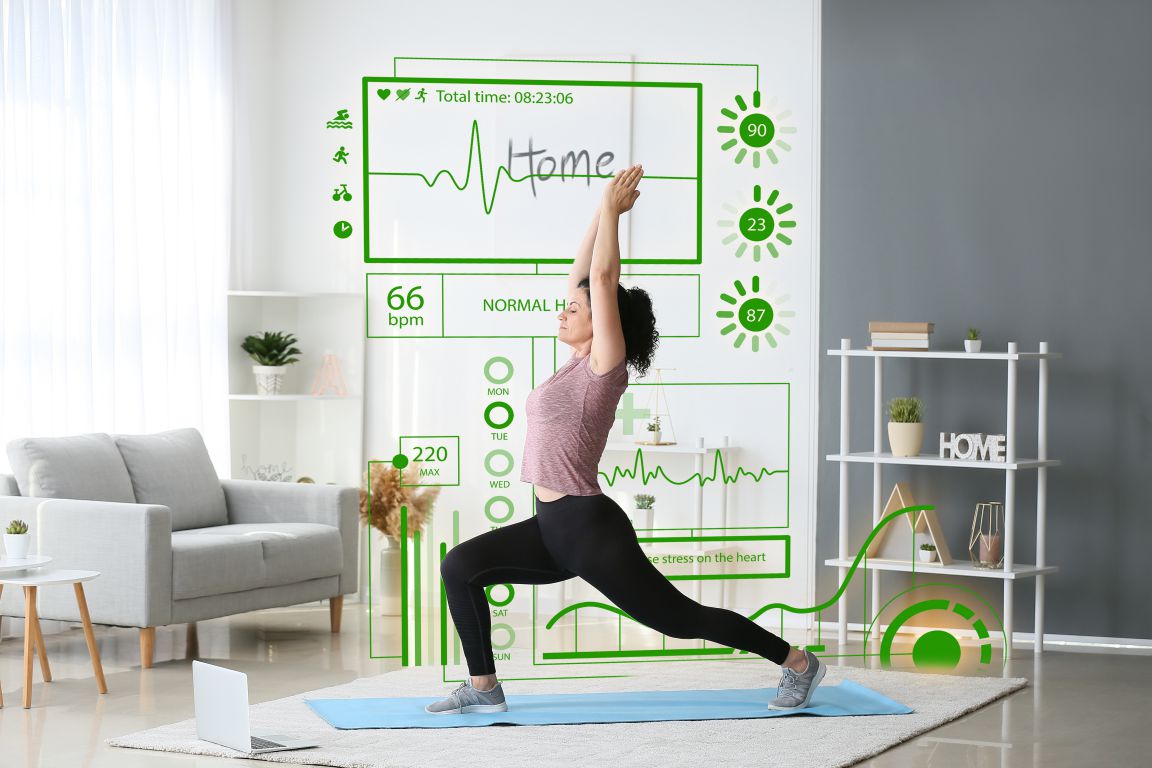 Virtual screen of heart rate monitor and sporty young woman practicing yoga at home